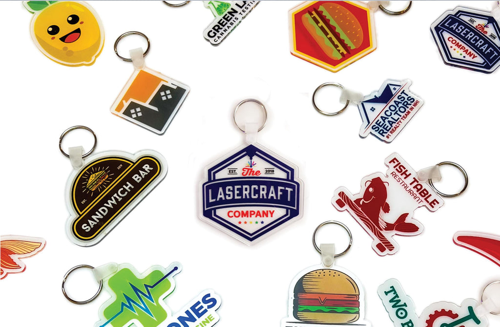 Custom logo keychains in full colour on 1/8 inch acrylic, cut to each logo's own shape