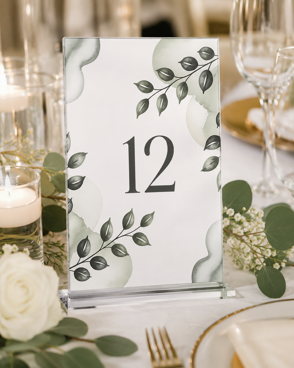 Custom acrylic rectangle table number, full-color greenery design, number 12, on a clear acrylic display stand at a wedding table